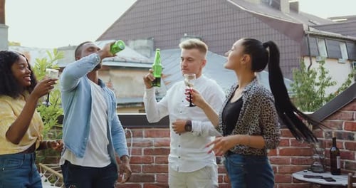 Mixed Race People Having Fun Together During Friends Party on the Terrace