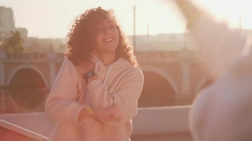 Energetic Woman Dancing Outdoors in Golden Hour
