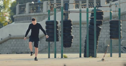 Attractive Young Athlete Does Warmup on the Summer Sports Field