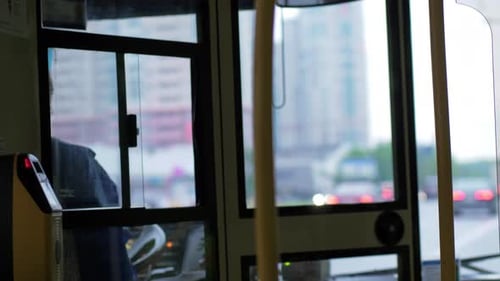 Woman driving bus in the city