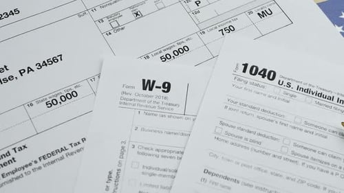 Tax Forms 1040, W2, W9 on American Flag