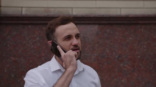 Close Up View of Man's Face with Black Phone