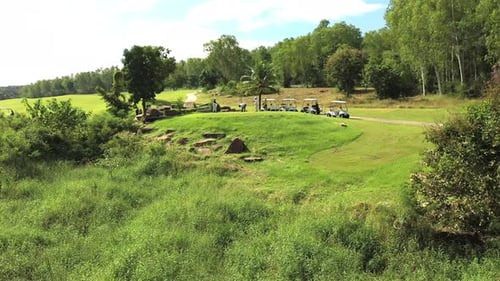 4K Aerial view group of Asian people golfing on at golf course in summer sunny day.