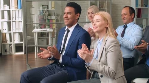 Business Team Applauds in Modern Office Setting