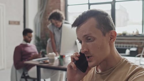 Man Talking on Mobile Phone in Office