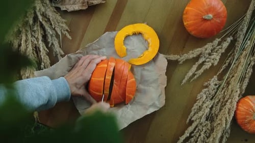 Woman Cutting Ripe Pumpkin