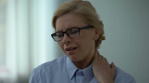 Woman Rubbing Neck Due to Pain
