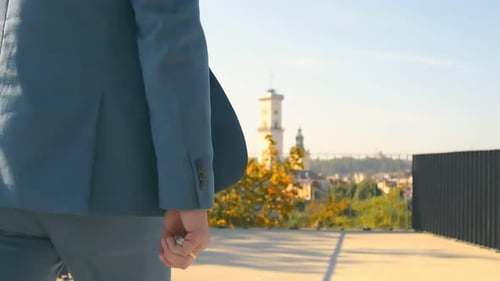 Businessman Goes Forward To His Goal. A Young Successful Man in a Jacket Is on His Way To Town.