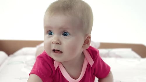 Adorable Baby Lies on Tummy Looking Around