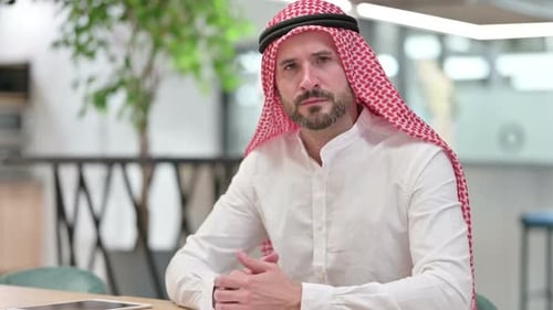 Man in Keffiyeh Gesturing with Finger