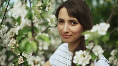 Portrait of a Woman Near Blooming Tree