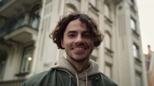 Cheerful Man Smiling on Urban Street