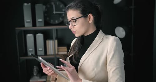 Attractive Woman Standing at Office with Tablet