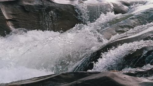 Wild Mountain River Flowing with Stone Boulders and Stone Rapids. Slow Motion