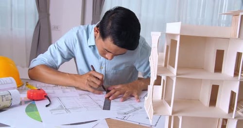 Male Architect Working On A Construction Project In The Office