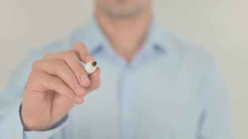 Hand Writes the Word Relax on Clear Surface