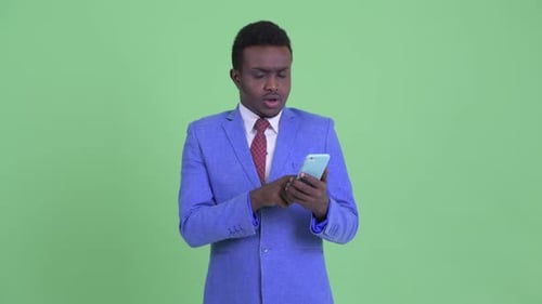 Young Adult Using Smartphone on Green Screen