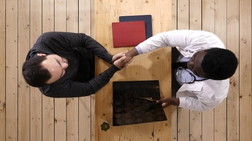 Doctor Explains Brain Scan to Patient Indoors