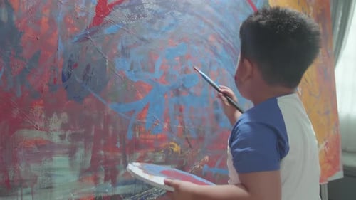 Child Painting Abstract Art on Canvas Indoors