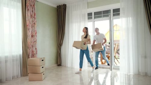 Happy Couple Moving Into New Home With Boxes