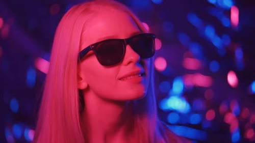 Stylish Woman with Sunglasses in Neon Light