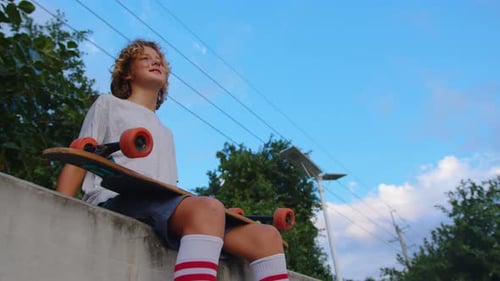 Thoughtful Skater Guy on Urban Background