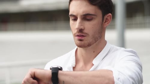 Handsome Man Using Smartwatch in Urban Setting