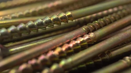 Golden Screws Fasteners in Close Up Dolly Shot