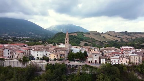 Aerial dolly out revealing a small Italian town in a mountain landscape
