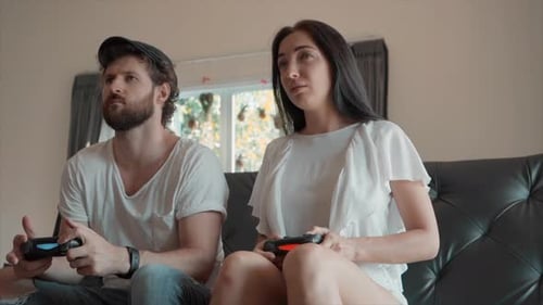 Excited Couple Plays Video Games Indoors