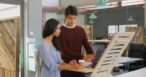 Executives discussing over laptop in the office 4k
