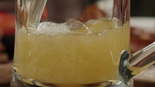 Pouring Frothy Beer in Glass Closeup