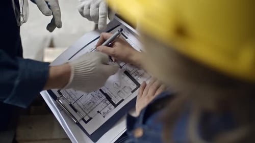 Engineers Discussing Construction Layout Plan