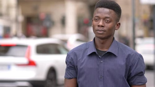 handsome young african american man observing the city