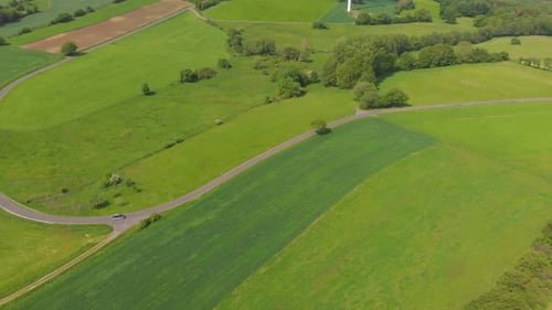 Car Travels Rural Road Through Green Fields