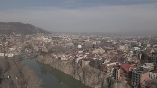 Aerial view of Metekhi church in old Tbilisi located on cliff near river Kura. Georgia 2021 winter