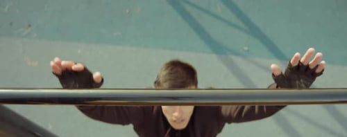 Man Doing Bar Pull-Up on Workout Playground