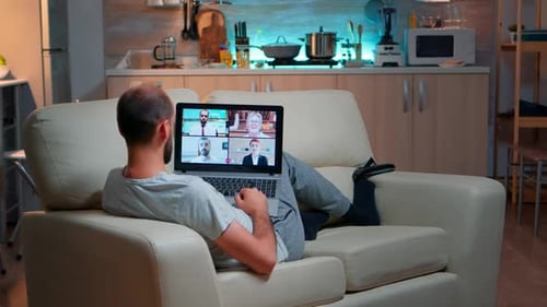 Man Relaxing on Couch During Video Conference