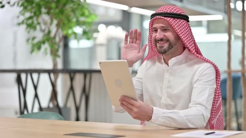 Adult having video call on tablet indoors