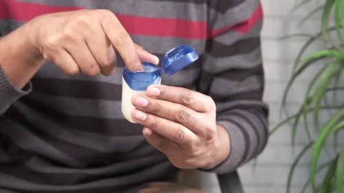 Close Up of Man Hand Using Petroleum Jelly