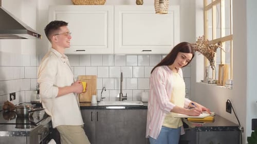 Young Couple Smiling in Modern Kitchen