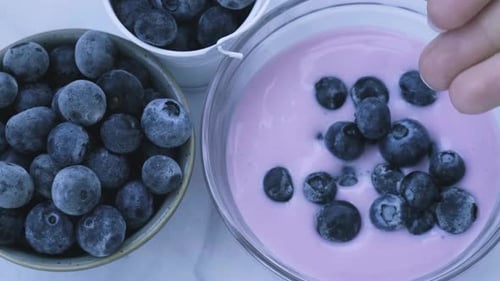 Bowl with Yogurt and Blueberries on Table