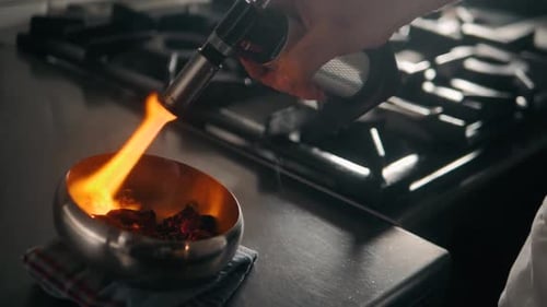 Red Chili Peppers and Herbs Spices with Fire on Modern Kitchen in Restaurant