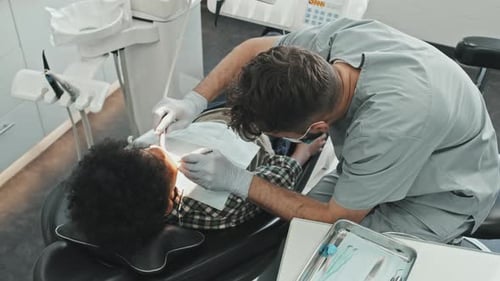 Dentist Examining a Child Patient in Dental Office
