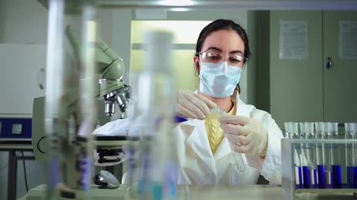 Woman Scientist Experimenting with Chemicals in Laboratory