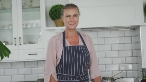 Woman Smiling in Bright White Kitchen