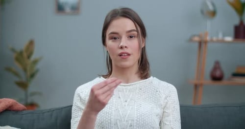 Young Woman Communicating Using Sign Language Indoors