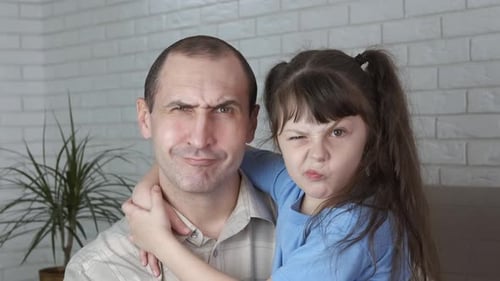 Father and Daughter Making Funny Faces Together