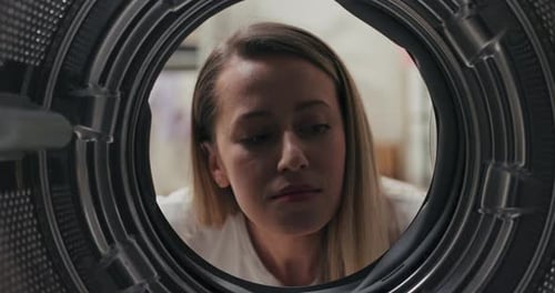 View From Inside the Drum a Woman Has Bought a New Washing Machine Looks at It Carefully Inside with