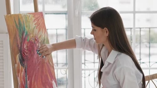 Woman Painting Colorful Abstract Art with Fingers